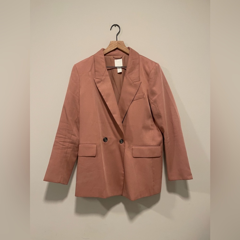 Salmon colored Womens blazer.